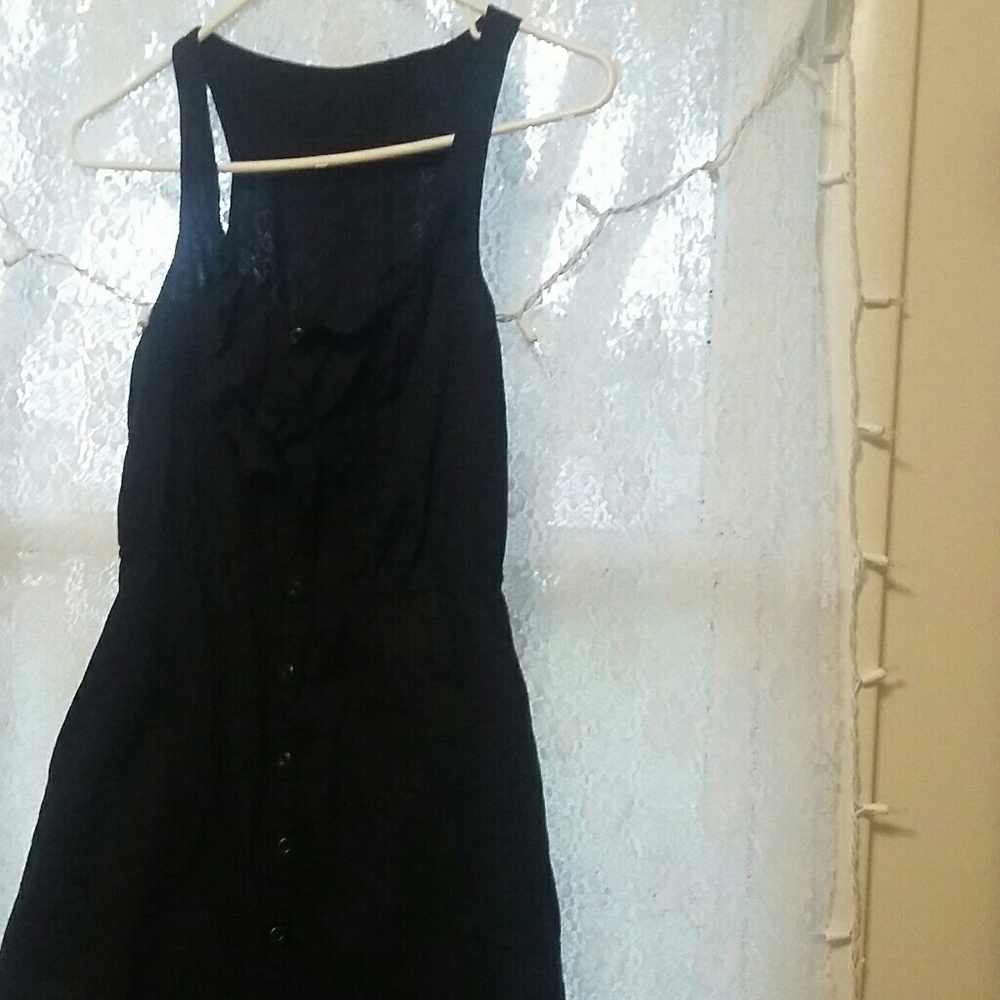 A black, button down sundress